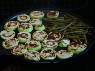 A close-up on some courgette sliced on a kitchen stove.