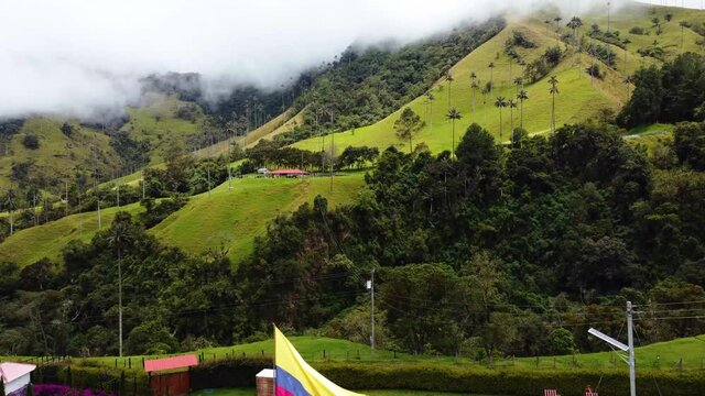 Aerial view of the Cocora Valley in Colombia with the highest palm trees in the world, Colombia flag in Salento