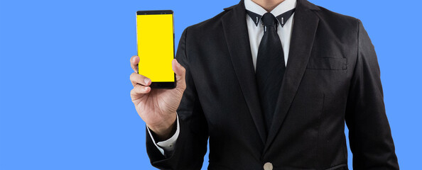 Man in business suit.show smartphone. Isolated on blue background. concept of digital service,...