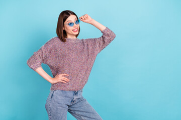 Photo of crazy coquette lady look empty space wear sunglass knitted sweater isolated blue color...
