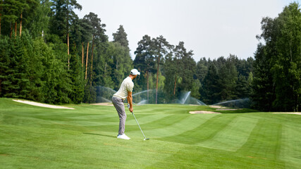 Fototapeta premium Young golfer playing golf outdoors