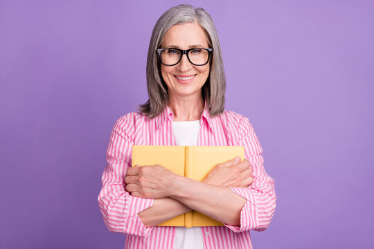 Photo of aged woman happy positive smile embrace book novel reader education isolated over violet color background