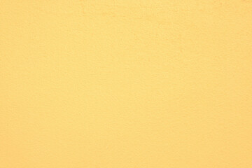 Bright yellow plastering wall texture for background.