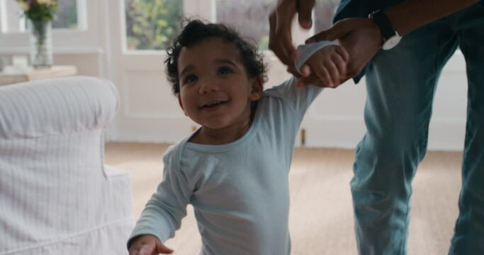 happy baby learning to walk toddler taking first steps with father helping infant teaching child at home 4k