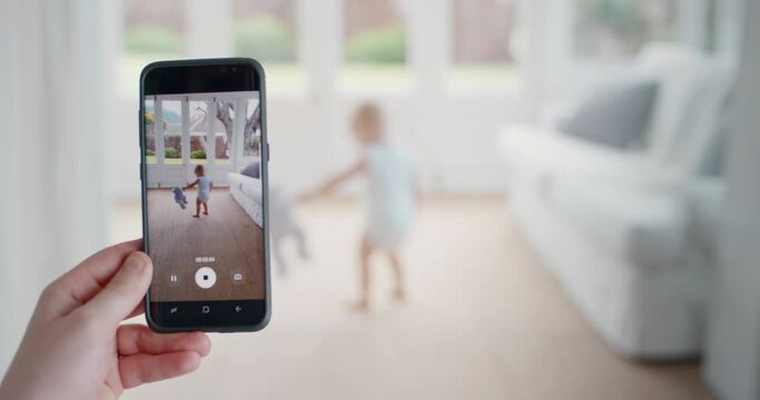 mother taking video of baby using smartphone enjoying photographing happy toddler with mobile phone camera sharing motherhood lifestyle on social media 4k footage