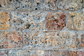 Close Up of Wall with Colourful Rough Textured Stone Blocks 