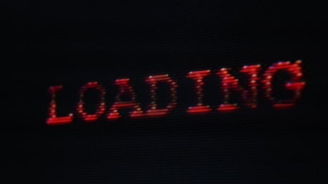 Loading distorted glitchy red text on vintage screen display - retro gaming, 80s and 90s vhs nostalgia concept