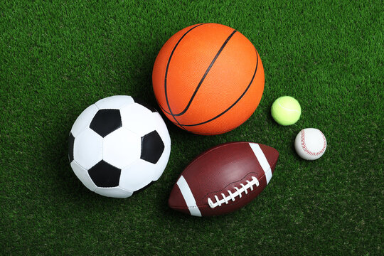 Set of different sport balls on green grass, flat lay © New Africa