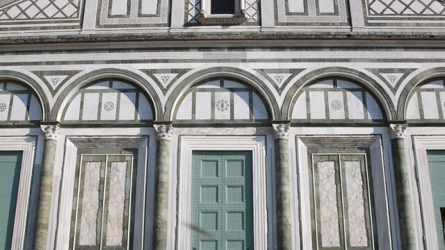 The facade of the famous Basilica of San Miniato in Florence. It is one of the best examples of Florentine Romanesque style. Tilt camera movement