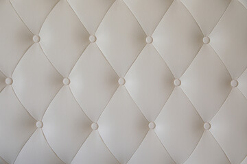 The texture of the leather upholstery of the back of the sofa