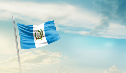Guatemala national flag cloth fabric waving on the sky - Image