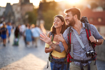 Naklejka premium Happy tourist couple sightseeing; Traveller lifestyle