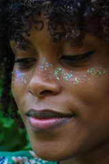 Portrait of a black woman with afro hair and glitter on her face