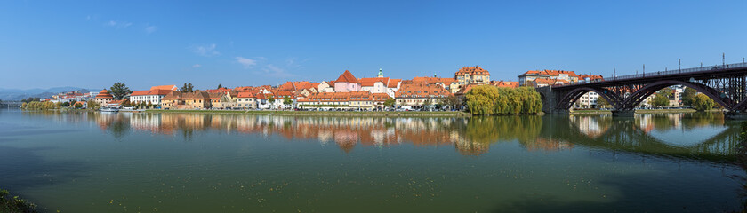 Fototapeta na wymiar Maribor, Slovenia. Panorama of historical part of the city from the shore of Drava river. Maribor is the second-largest city in Slovenia and the largest city of the traditional region of Lower Styria.