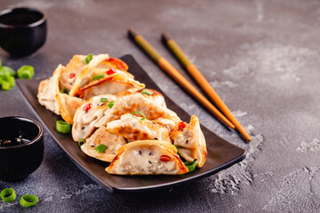 Fried dumplings served with green onions.