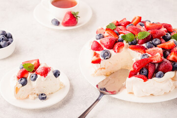 Delicious Pavlova cake with fresh strawberry and blueberry