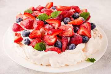 Delicious Pavlova cake with fresh strawberry and blueberry
