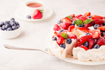 Delicious Pavlova cake with fresh strawberry and blueberry