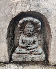 an ancient stone Buddha statue in Nepal. ancient stone carving.