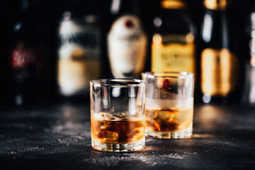 Whiskey with ice on a dark table