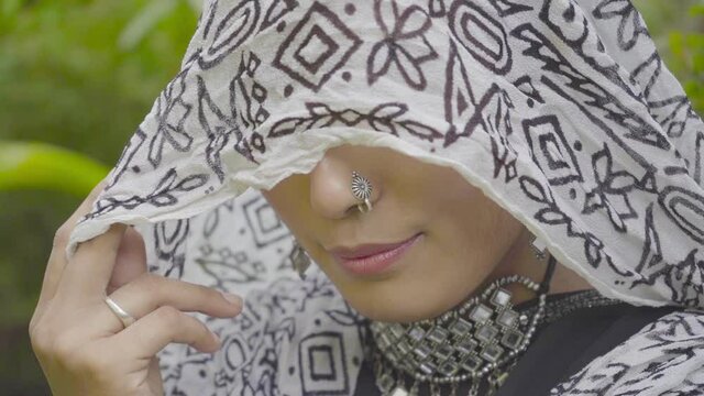 Close up of Indian young woman covered her face with headscarf, India