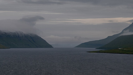 Beautiful view of the Faroe Islands landscape of lakes, ocean, fishermans villages, and boats