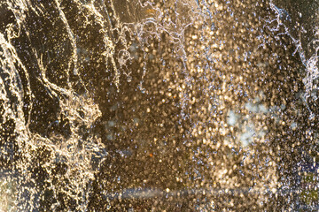 Background, an abstraction of water jets and drops of a fountain