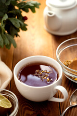 Cup of herbal tea. Warm delicious cup of refreshing herbal tea on wooden background.