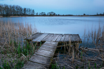 A wooden platform for anglers by the lake shore