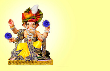 Hindu God Ganesha on colorful background, with copy space, Ganesha is the patron of arts and...