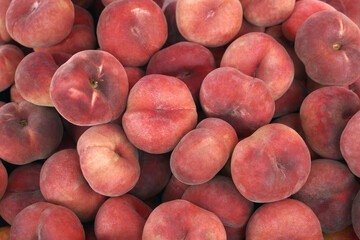 harvest of fresh fig flat peaches. background, food texture or wallpaper.agricultural products, sale in farmers market.
