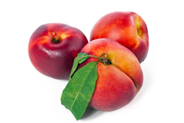 Ripe nectarine fruits with leaves isolated on a white background