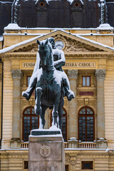 Snowy statue of King Carol I in Bucharest, Calea Victoriei in front of the National Library...