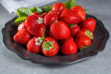 Tin board with fresh ripe red sweet strawberries