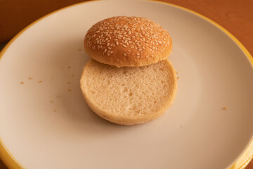 Sesame seed hamburger bun whole piece on plate ready