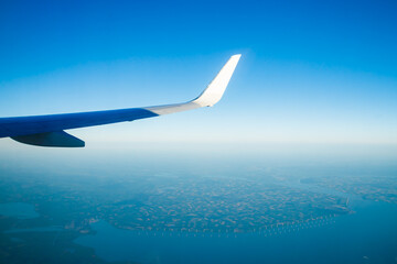 Fototapeta na wymiar Amsterdam, Netherlands - 17 July 2021: KLM Plain wing over Holland. Flight from Amsterdam to Helsinki.