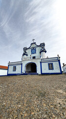Church of Nossa Senhora da Visitação in Montemor-o-Novo, Portugal. White church in Alentejo with typical blue stripe. 