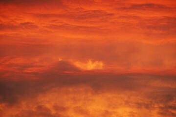 a red sunset with clouds on the horizon in the evening . sky background in red and orange tones