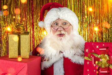 Fototapeta na wymiar Emotional senior male model old man with a natural white beard in the role of Father Christmas