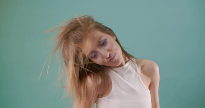 Dancing while flipping her hair