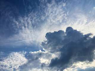 Naklejka na ściany i meble Natural background. Blue sky with clouds. Close-up.