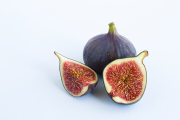 Close-up on ripe blue figs on the white background. Copy space.