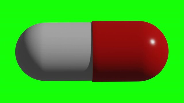 Loopable on Green Screen: Rotating red and white capsule pill isolated on green screen background.