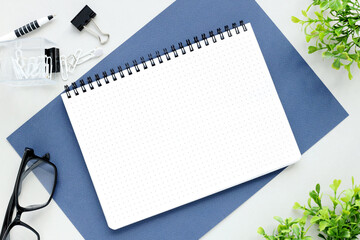 Top view of blank note paper with pen on blue wood table for background. Back to school and education concept