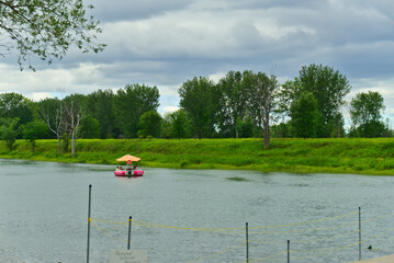 Boucherville, QC, Canada, 7-30-2021, a group of people on a donut boat in Lawrence (Laurent) River,...
