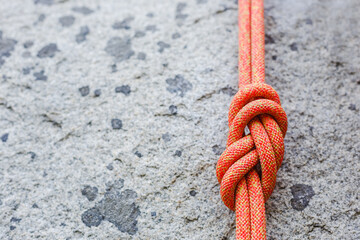eight rope knot on rocky background