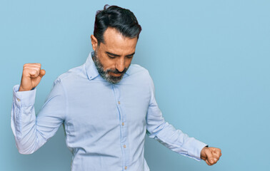Middle aged man with beard wearing business shirt dancing happy and cheerful, smiling moving casual and confident listening to music