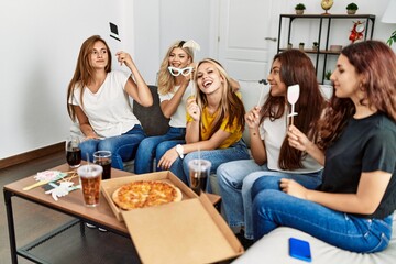 Group of young friends woman having party with costume accessories at home.