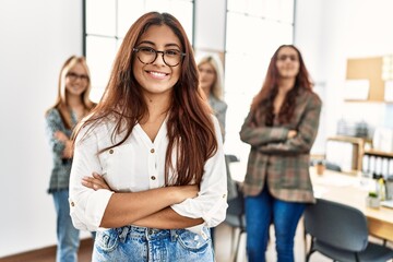 Group of young businesswoman smiling happy standing with arms crossed gesture at the office.