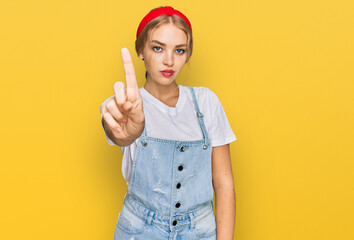 Young caucasian girl wearing casual clothes pointing with finger up and angry expression, showing no gesture